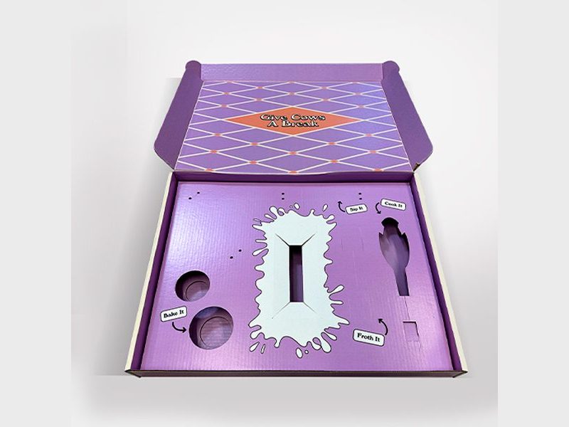 Bored Cow purple mailer box open to a die-cut foam tray by VSL Packaging