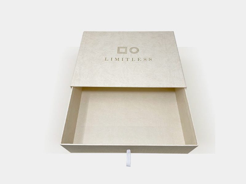 Limitless cream drawer box open with a ribbon pull tab by VSL Packaging