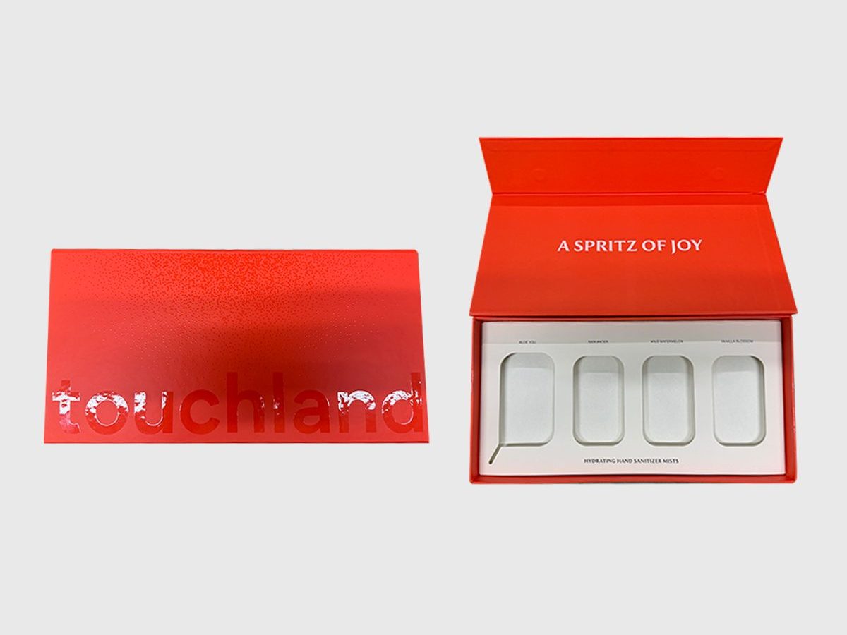 Touchland red box shown closed and open to a four-cavity foam tray by VSL Packaging