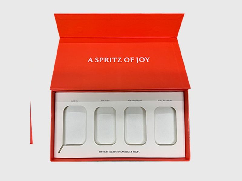 Red foil-print Touchland shoulder box, open, with a four-cavity tray, by VSL Packaging