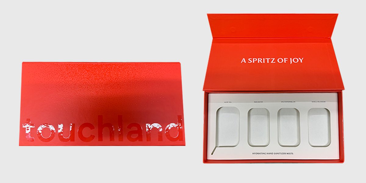 Touchland red foil-print shoulder box, closed and open with a four-cavity tray