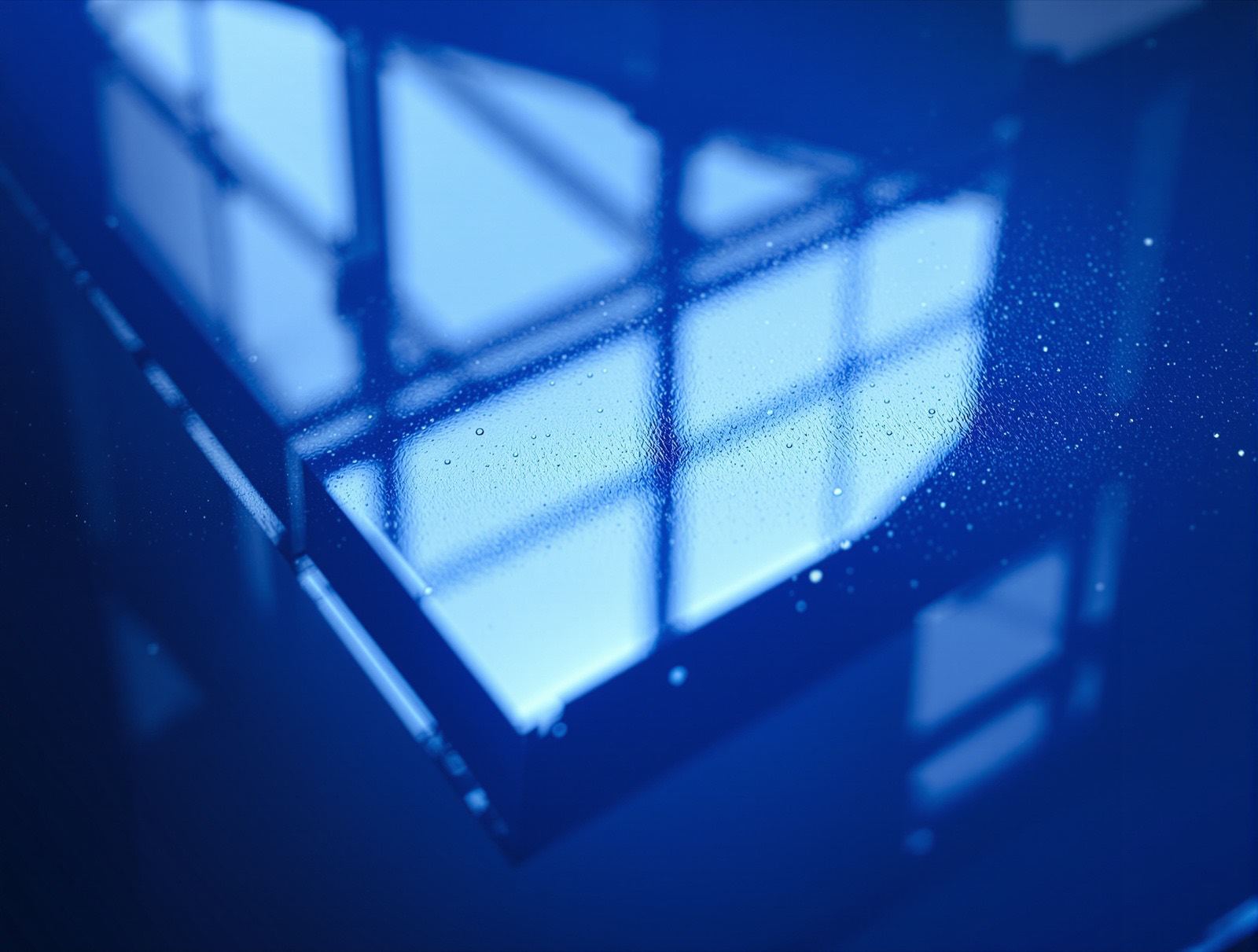 A softbox reflection mirrored on a wet-look glossy deep blue box panel — studio image