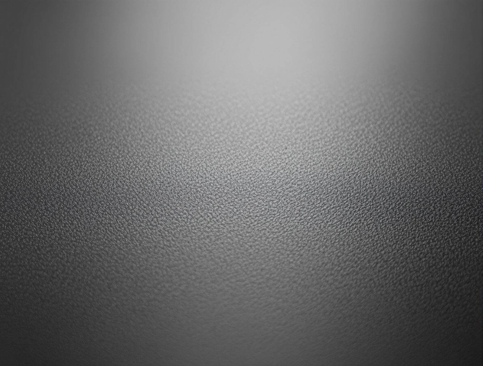 Macro of a matte laminate surface, micro-texture visible, zero glare — studio image